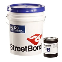 A white bucket of StreetBond SB120 paint with a blue lid and a smaller black can labeled 'B' beside it.